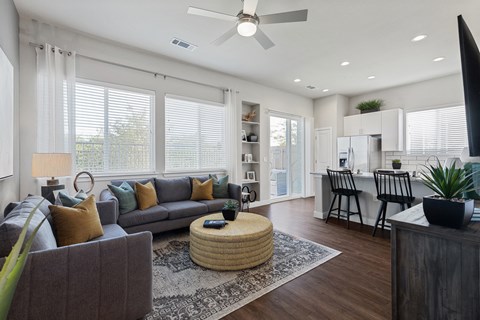 an open living room and kitchen with a couch and a table